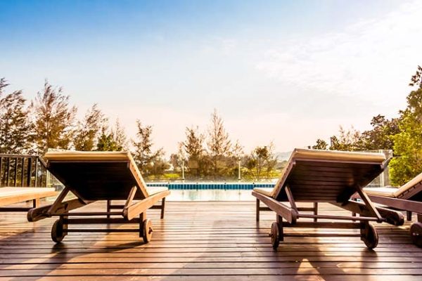 Empty chair and swimming pool at hotel resort - Vintage Filter